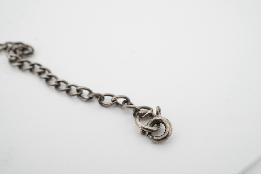 A silver military bracelet stamped sterling, and engraved ‘43450 G.W. Day, RAF C.ofE.’ X prisoner of war at Stalag prison. Condition - fair to good, one link requires rejoining.